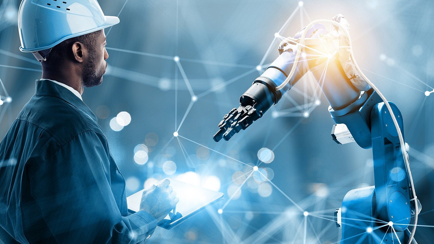 Kendrion robotic arm with colloborater and glow on the right. Blue background with white lines.