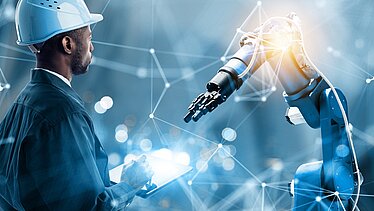 Kendrion robotic arm with colloborater and glow on the right. Blue background with white lines.